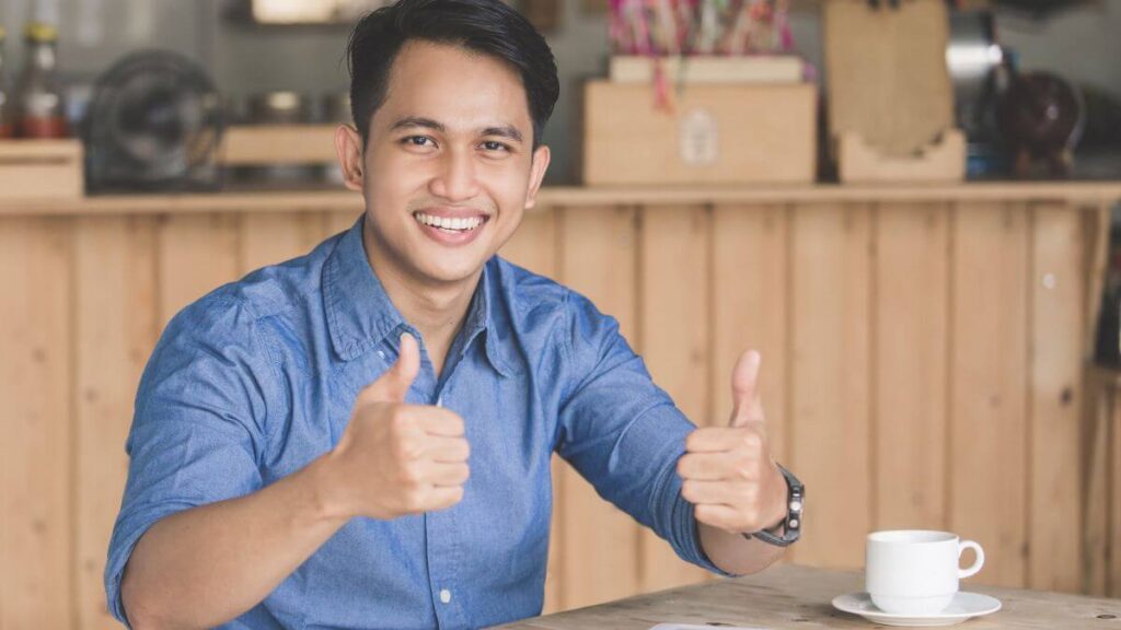 a happy customer giving thumbs up