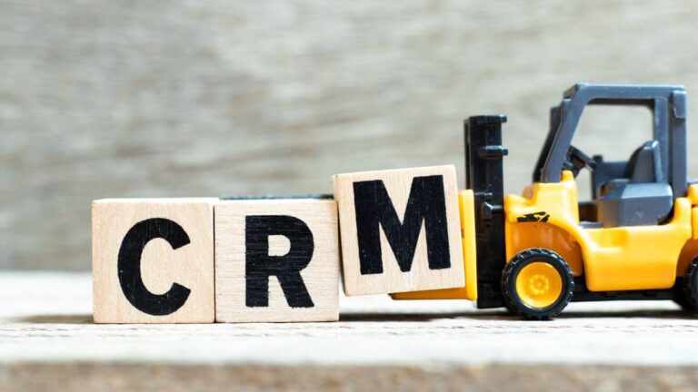 a toy truck pushing blocks labeled CRM