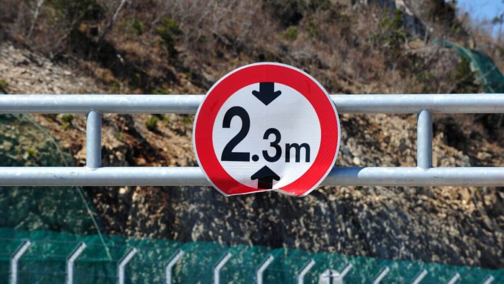a signage showing height limit of 2.3 m